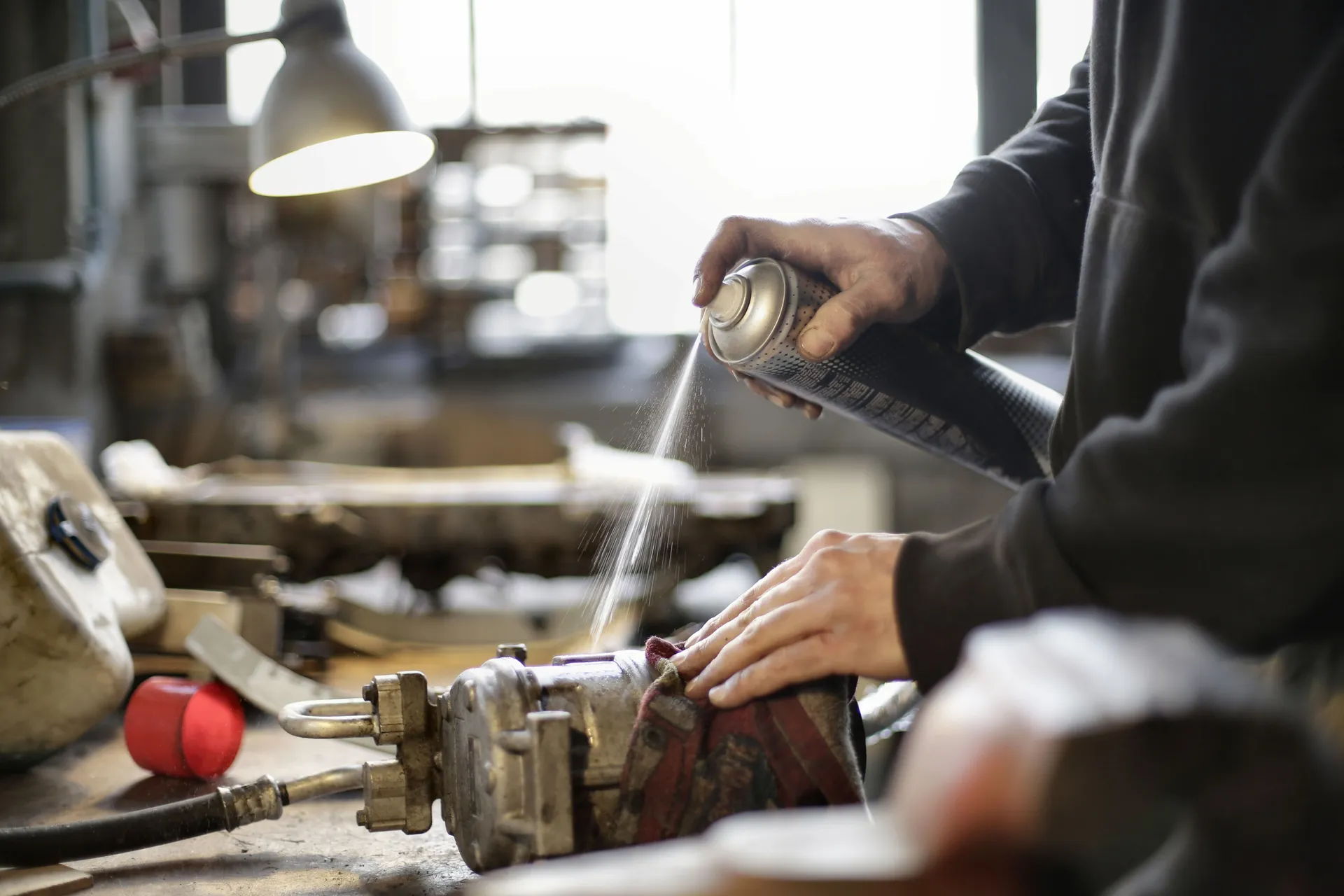 Professional HVAC technician cleaning evaporator coils with specialized tools - how often should you schedule an ac tune up