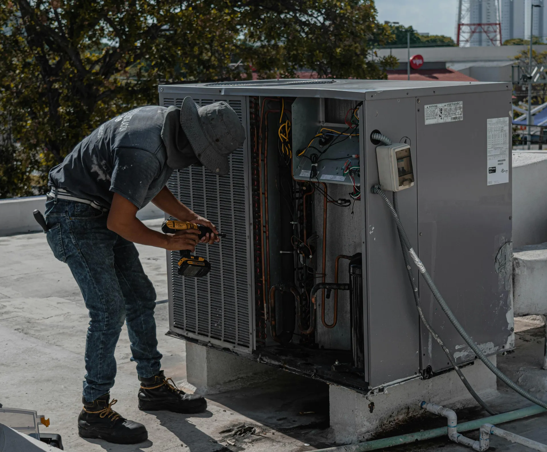 Professional HVAC technician inspecting an outdoor unit with digital gauges - does a new ac help sell your home faster